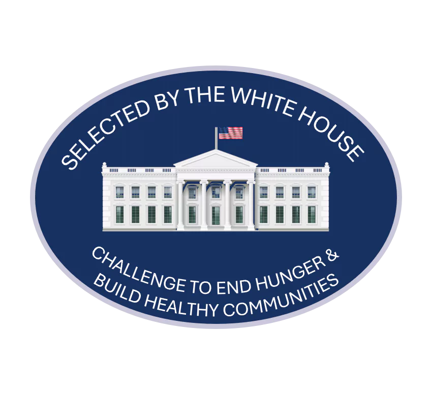 The white house depicted in an oval seal, surrounded by the words "Selected by the White House Challenge to End Hunger & Build Healthy Communities"